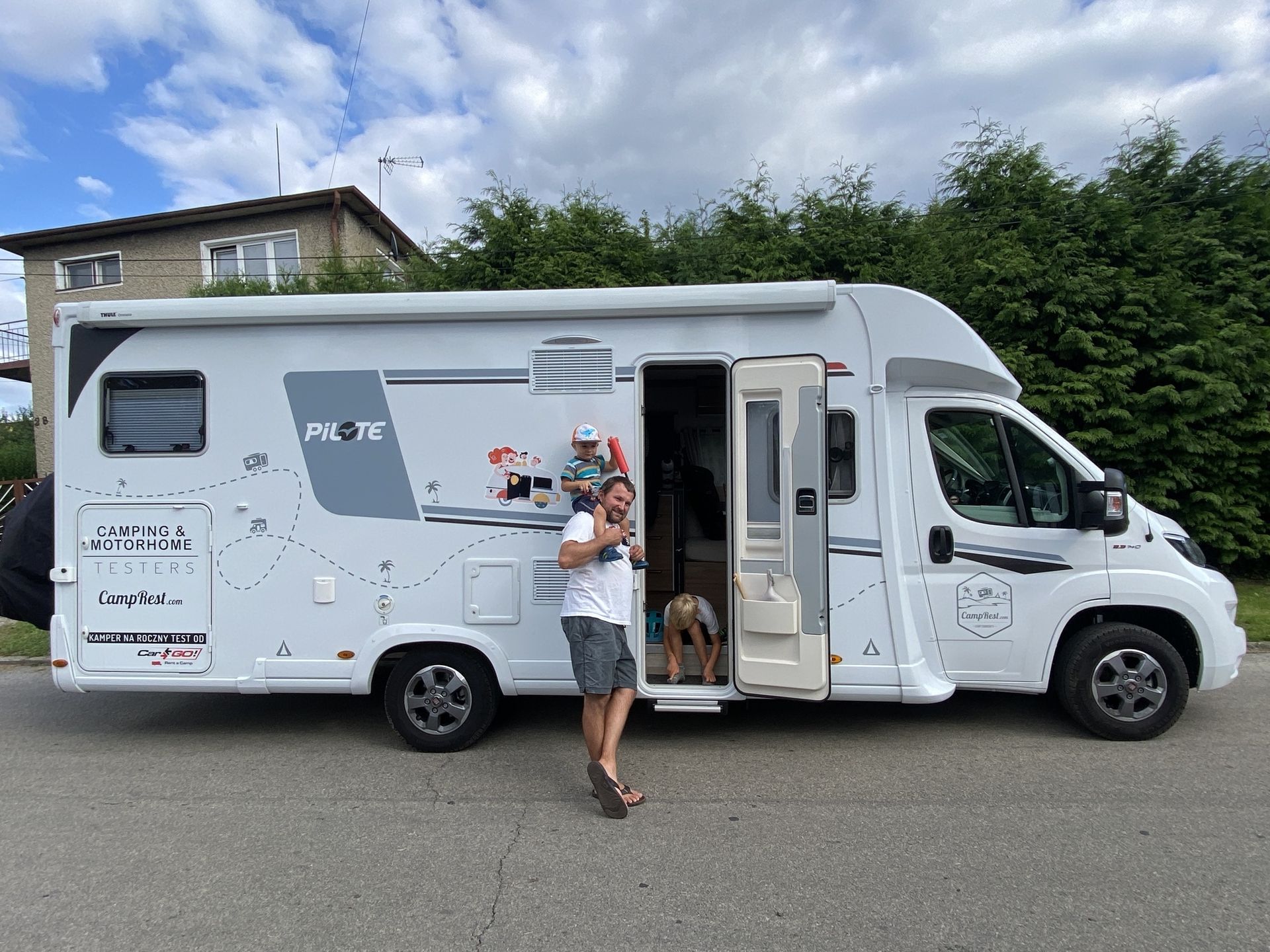 Family in front of a campervan, campervan vacation